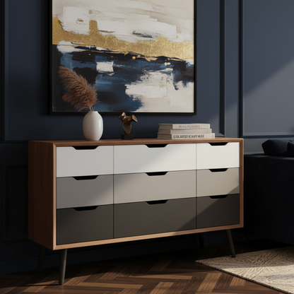 A mid-century modern 6-drawer dresser with a light oak wood frame, white and gray drawer fronts, and black legs, styled in a minimalist room with decorative items on top.