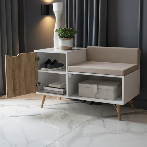 A modern white entryway console cabinet with a built-in upholstered bench seat, open shelving, and a hinged wood door. The cabinet is styled in a home setting with a vase, plant, shoes, books, and storage boxes inside.