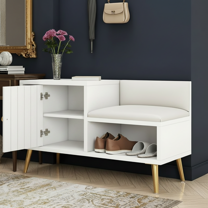 A modern white entryway bench with a cabinet door, upholstered seat, and open lower shelf for shoes, styled in a room against a dark navy wall with a side table, mirror, and decor.