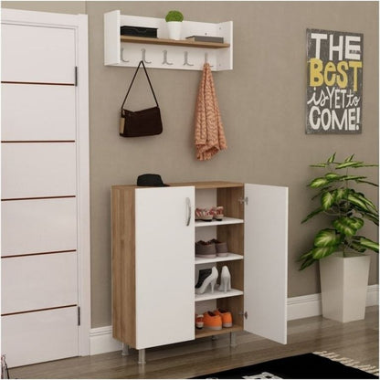 A white and light wood entryway shoe cabinet with open doors, shown in a styled room with a wall-mounted hook rack, hanging bag, scarf, shoes on shelves, a door, wall decor, and a potted plant.