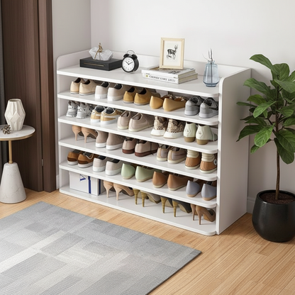 A white 5-tier shoe rack organizer filled with various casual, heeled, and flat shoes, styled in a home entryway setting with decorative items on top.
