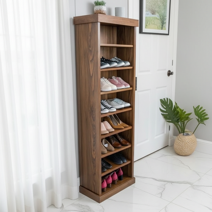 A tall wooden shoe rack with five shelves stands in a bright room next to a white door and curtain, holding various pairs of shoes. A potted green plant is on the floor in the background.