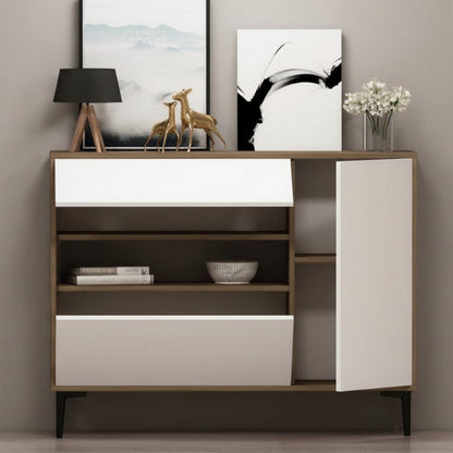 A modern wooden sideboard cabinet with white front panels, open shelves, and a side door, styled with a lamp, framed wall art, deer figurine, flowers, and books against a neutral gray wall.
