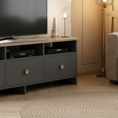Modern living room with a television on a wooden stand, plant, and sofa.