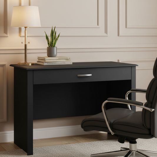 Black office desk with a chair and decorative items in a room with beige walls.