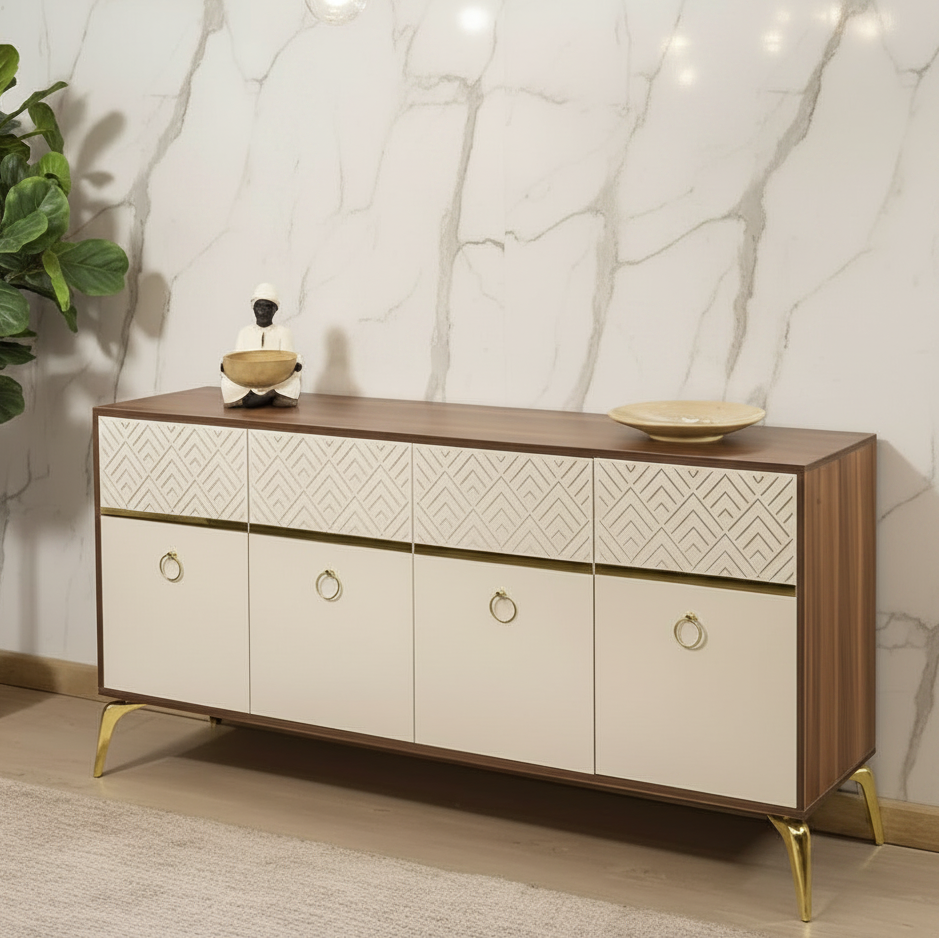 A modern sideboard or credenza with a dark wood top and frame, cream-colored lower cabinet doors, geometric patterned drawer fronts, and gold-tone legs and ring pulls, shown in a styled interior setting with two hexagonal mirrors and wall paneling.